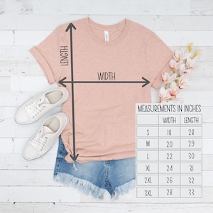May include: A peach-colored t-shirt with a size chart showing width and length measurements in inches.