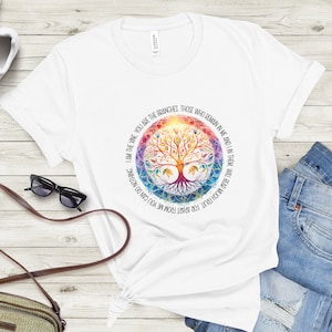May include: White t-shirt with a colorful tree of life design and the text "I am the vine you are the branches, those who remain in me and I in them, will bear much fruit for apart from me you can do nothing."