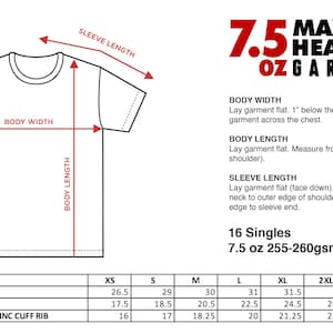 May include: A technical sizing chart for a 7.5 oz heavyweight garment dye t-shirt. The diagram illustrates body width, body length, and sleeve length measurements. A detailed table provides specific dimensions in inches for sizes XS through 5XL.