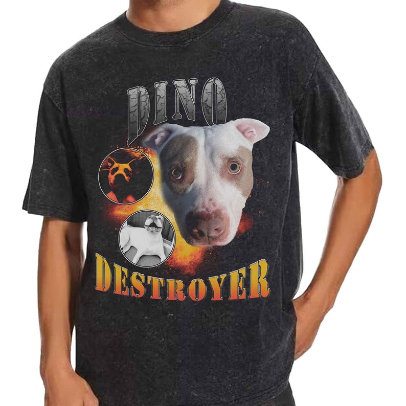 以下が含まれることがあります： チャコールグレーのアシッドウォッシュ加工Tシャツ。ピットブルの顔の大きなグラフィックプリント、同じ犬の2つの小さな円形画像、そして前面に太字のオレンジと黄色のグラデーションフォントで「DINO DESTROYER」というテキストがデザインされています。