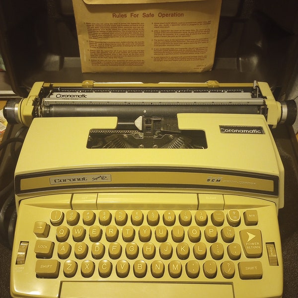 Smith Corona Coronet Super 12 Electric Portable Typewriter with original case and owner's manual.