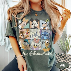May include: A dark green t-shirt featuring a grid of nine squares, each displaying a different Disney character including Mickey Mouse, Minnie Mouse, Goofy, Donald Duck, Daisy Duck, Pluto, Stitch, and Chip 'n Dale, with the text Walt Disney World.