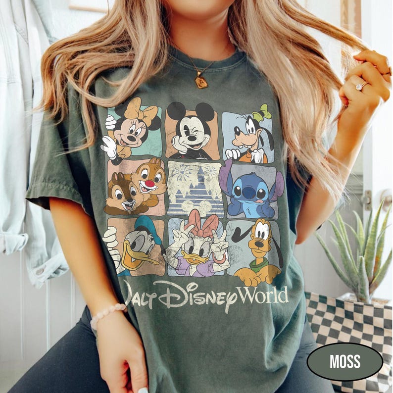May include: A dark green t-shirt featuring a grid of nine squares, each displaying a different Disney character including Mickey Mouse, Minnie Mouse, Goofy, Donald Duck, Daisy Duck, Pluto, Stitch, and Chip 'n Dale, with the text Walt Disney World.