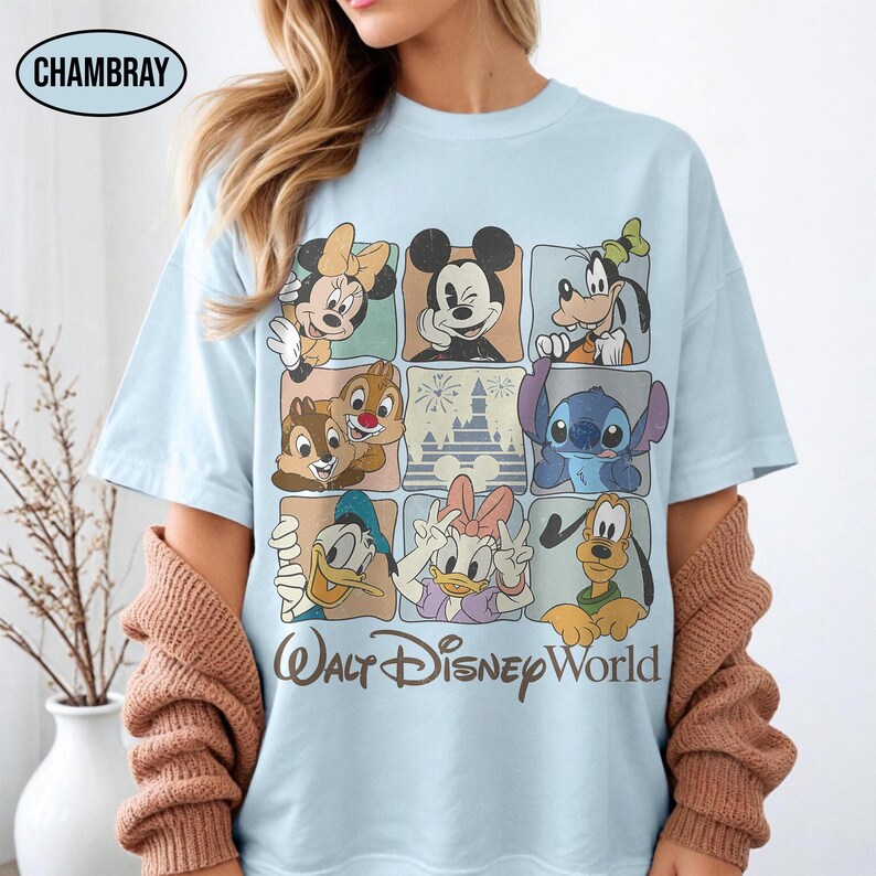 May include: A light blue t-shirt featuring a grid of Disney characters including Mickey Mouse, Minnie Mouse, Goofy, Chip, Dale, Stitch, Donald Duck, Daisy Duck, and Pluto, with a castle graphic and the text Walt Disney World below.