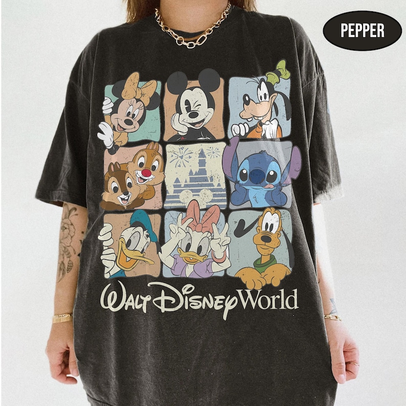 May include: A charcoal gray short-sleeve t-shirt featuring a grid of nine squares with various Disney characters including Mickey Mouse, Minnie Mouse, Goofy, Stitch, Donald Duck, Daisy Duck, Pluto, Chip, and Dale, with the text Walt Disney World.