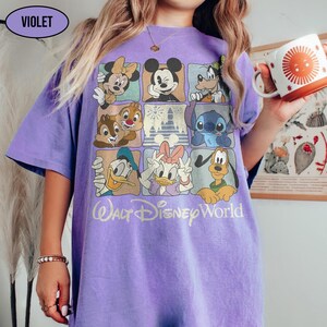 May include: A violet short-sleeve t-shirt featuring a grid of nine squares with various Disney characters including Mickey Mouse, Minnie Mouse, Donald Duck, Daisy Duck, Goofy, Pluto, Chip, Dale, and Stitch, with the text Walt Disney World below.