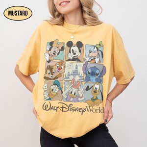 May include: A mustard yellow short-sleeve t-shirt featuring a grid of nine squares with various Disney characters including Mickey Mouse, Minnie Mouse, Goofy, Donald Duck, Daisy Duck, Pluto, Stitch, and Chip 'n Dale, with the text Walt Disney World.