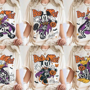 May include: A collection of six cream-colored t-shirts, each featuring a different Disney character dressed in a skeleton costume and purple cape. The graphic includes the text "Boo You!", spiderwebs, bats, and candy corn, with character names.