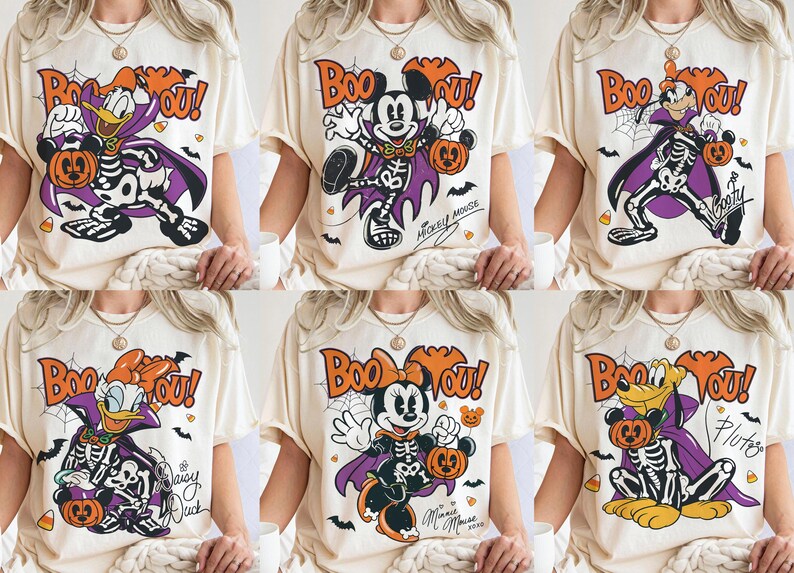 May include: A collection of six cream-colored t-shirts, each featuring a different Disney character dressed in a skeleton costume and purple cape. The graphic includes the text "Boo You!", spiderwebs, bats, and candy corn, with character names.