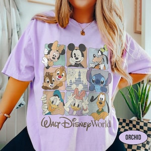 May include: A light purple t-shirt featuring a grid of nine squares with illustrations of various cartoon characters, including Mickey Mouse, Minnie Mouse, Goofy, Stitch, Donald Duck, Daisy Duck, Pluto, Chip, and Dale, with the text Walt Disney World.