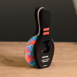 Make every strike count with this Personalized Wooden Bowling Trophy featuring acrylic details. A custom award designed for corporate sports gifts, league champions, and bowling competition winners.