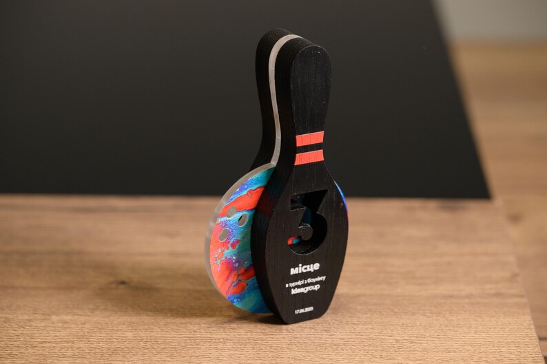 Make every strike count with this Personalized Wooden Bowling Trophy featuring acrylic details. A custom award designed for corporate sports gifts, league champions, and bowling competition winners.