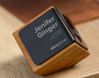 May include: A wooden award with a black plaque that reads "Jenifer Ginger Best Manager of the year 2023 ideagroup".