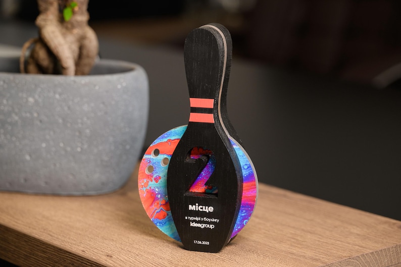 Recognize top bowlers with this Personalized Wooden Bowling Trophy, a high-quality custom award with acrylic details. A stylish corporate sports gift for professional and amateur bowling events.
