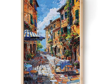Puede incluir: Una pintura de una calle estrecha y adoquinada en una ciudad europea. La calle está bordeada de edificios coloridos, y hay mesas y sillas dispuestas fuera de un café. El cielo es azul y soleado, y hay flores creciendo en macetas a lo largo de la calle.
