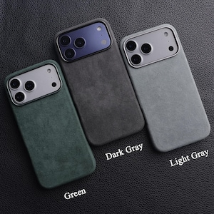 May include: Three phone cases in green, dark gray, and light gray, arranged on a textured black surface. Each case has a silver camera module and a matching colored back. The labels "Dark Gray", "Light Gray", and "Green" are visible.