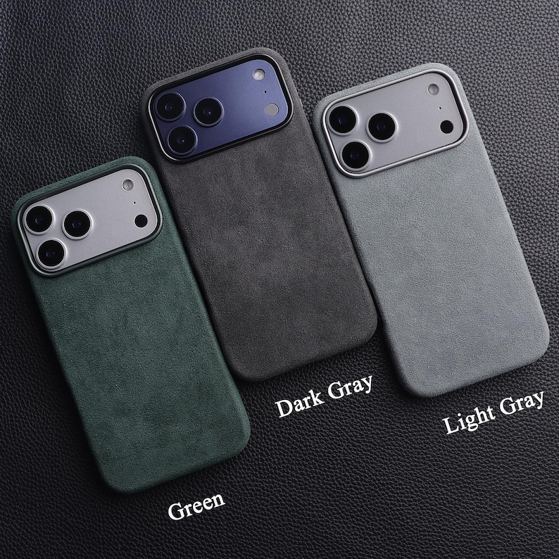 May include: Three phone cases in green, dark gray, and light gray, arranged on a textured black surface. Each case has a silver camera module and a matching colored back. The labels "Dark Gray", "Light Gray", and "Green" are visible.