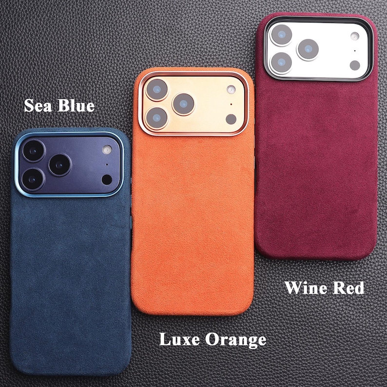 May include: Three phone cases in sea blue, luxe orange, and wine red. Each case has a textured finish and a camera cutout. The sea blue case has a blue camera ring, the luxe orange case has a gold camera ring, and the wine red case has a silver camera ring.