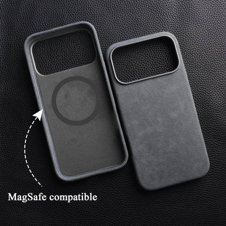 May include: Two gray phone cases with a textured finish are displayed on a dark surface. One case has a circular design, and the other has a rectangular opening. The text "MagSafe compatible" is also visible.