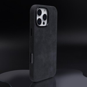 May include: A black phone case with a textured, suede-like finish. The case has a raised camera bump with three lenses.