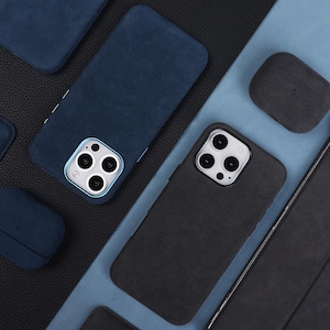 May include: Assortment of phone cases and AirPod cases in blue and black suede fabric. The cases have a textured finish and are designed to protect electronic devices.