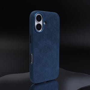 May include: A dark blue phone case with a textured suede finish. The case has a raised camera bump with two lenses.