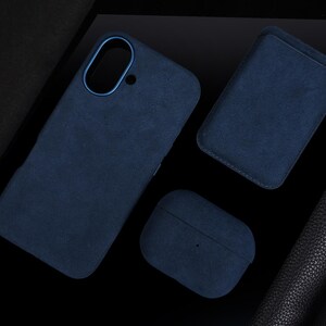 May include: Three blue suede cases, one for a phone, one for a wallet, and one for a pair of earbuds.