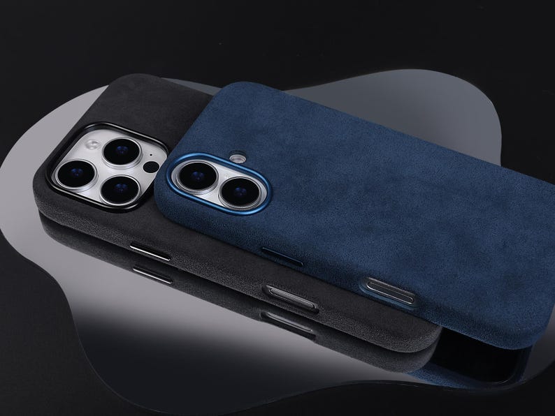 May include: Two phone cases, one gray and one blue, made of a soft, textured material. Both cases have a raised camera bump.