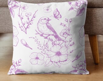 以下が含まれることがあります： 鳥、蝶、花が描かれた紫色の花柄の白いクッション。デザインは繰り返しパターンです