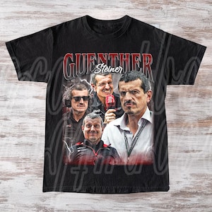 Puede incluir: Camiseta negra con un collage de imágenes de Guenther Steiner, con el nombre "GUENTHER Steiner" en texto rojo y blanco. El diseño incluye múltiples imágenes del sujeto en varias poses, con un estilo vintage.
