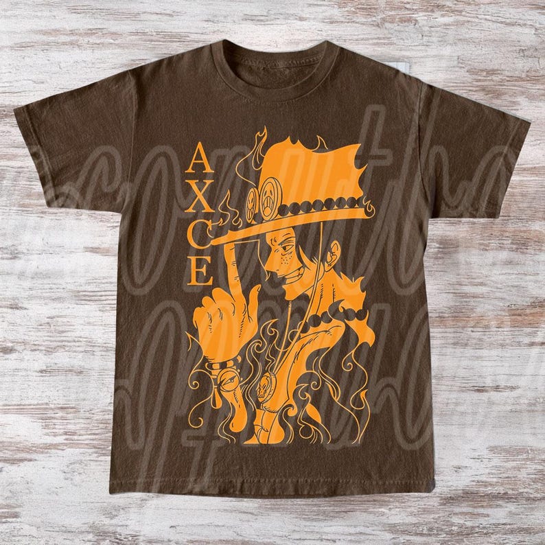 以下が含まれることがあります： 茶色のTシャツ。オレンジ色のイラストで、帽子をかぶったキャラクターと「ACE」の文字が描かれています。キャラクターは指を指しています。デザインには炎とネックレスが含まれています。カジュアルウェアです。