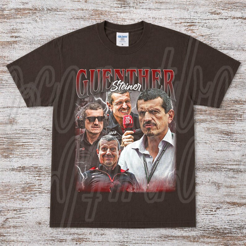 May include: A brown t-shirt featuring a graphic of Guenther Steiner, with multiple images of him and the text "GUENTHER Steiner" in red and white. The shirt has a crew neck and short sleeves.