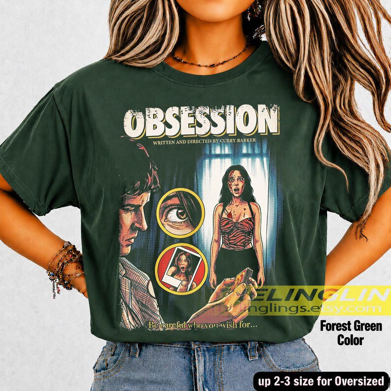 K&ouml;nnte beinhalten: Forstgr&uuml;nes &uuml;bergro&szlig;es T-Shirt mit dem Wort "OBSESSION" in einer Vintage-Schriftart. Das Shirt zeigt ein Filmplakat-Design mit einem Mann, einer Frau und dem Text "Written and Directed by Curry Barker". Der Text "Becarefid who you wish for..." ist ebenfalls sichtbar.