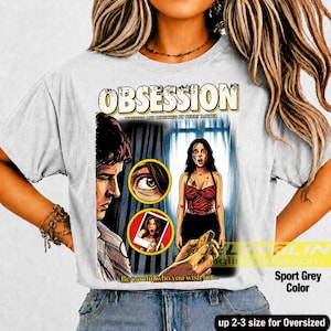 K&ouml;nnte beinhalten: Sportgraues T-Shirt mit einem Grafikdesign im Filmplakatstil. Das Wort "OBSESSION" steht oben. Die Grafik zeigt einen Mann, eine Frau und den Text "Be careful who you wish for..."