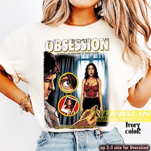 K&ouml;nnte beinhalten: Elfenbeinfarbenes T-Shirt mit einem Vintage-Filmplakat-Design, das den Titel "OBSESSION" zeigt. Die Grafik enth&auml;lt Illustrationen eines Mannes und einer Frau sowie den Text "Be careful who you wish for...". Das Shirt ist in 2-3 Gr&ouml;&szlig;en f&uuml;r eine &uuml;bergro&szlig;e Passform erh&auml;ltlich.