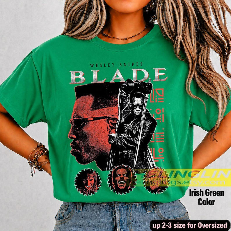 May include: A bright green short-sleeve t-shirt featuring a graphic print of Wesley Snipes as Blade. The design includes the text BLADE, a profile portrait, a full-body figure holding a sword, and three circular character icons at the bottom.