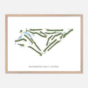 May include: A framed print featuring a golf course map in green and blue on a white background. The text "BUNDABERG GOLF COURSE" is printed in a simple font at the bottom of the image. The frame is a light wood color.