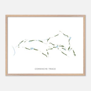 May include: A framed print featuring a golf course map with green and blue details on a white background. The course layout is depicted with lines and shapes, and the text "COMANCHE TRACE" is printed at the bottom.