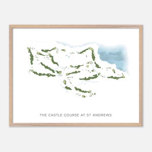 May include: A framed watercolour print depicting The Castle Course at St Andrews golf course. The image shows green fairways and a blue water feature. The text 'THE CASTLE COURSE AT ST ANDREWS' is printed at the bottom.