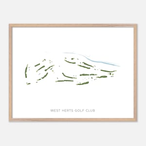 May include: A framed print of the West Herts Golf Club course layout. The course is depicted in green and tan against a white background, with a light blue water feature. The text "WEST HERTS GOLF CLUB" is printed at the bottom.