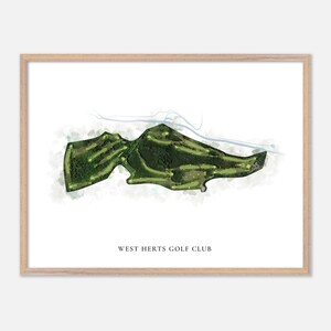 May include: A framed print featuring a watercolor-style map of a golf course. The course is depicted in shades of green, with fairways and greens visible. The text "WEST HERTS GOLF CLUB" is printed at the bottom of the image.