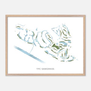 May include: A framed watercolor print of the TPC Sawgrass golf course. The artwork features a map-like design with green, blue, and gold accents. The text "TPC SAWGRASS" is printed in a simple font at the bottom of the image.