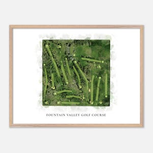 May include: Watercolor print of a golf course layout, featuring green fairways and white golf ball markers. The print is framed in a light wood frame. The text "FOUNTAIN VALLEY GOLF COURSE" is printed at the bottom.