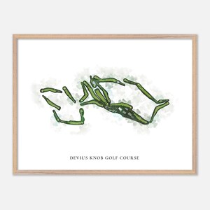 May include: A framed print featuring a watercolor-style golf course layout in shades of green. The text "DEVIL'S KNOB GOLF COURSE" is printed in a simple font at the bottom of the image. The frame is a light wood color.