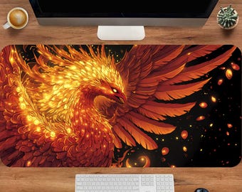 May include: A rectangular desk mat featuring a vibrant illustration of a phoenix. The artwork showcases the mythical bird in shades of orange, red, and gold against a black background. The phoenix is depicted with outstretched wings and fiery details.