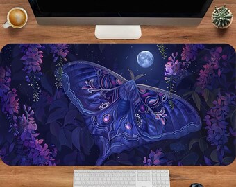 May include: A rectangular desk mat featuring a large, detailed moth with deep blue and purple wings, surrounded by hanging wisteria flowers and a full moon against a dark night sky. The text ArtisanPadsCo is visible on the computer monitor.