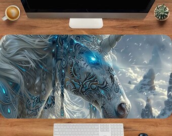 May include: A white unicorn with blue and black markings on its face and body. The unicorn is set against a snowy mountain background with a cloudy sky.