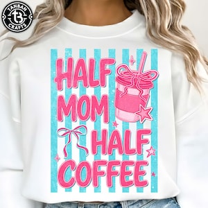May include: White sweatshirt with the text "HALF MOM HALF COFFEE" in pink, set against a backdrop of blue vertical stripes. A pink coffee cup graphic with a bow and star accents is also featured.