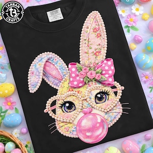 May include: Black sweatshirt featuring a detailed, colorful bunny face with glasses, a pink bow, and a bubblegum bubble. The bunny has floral and polka dot patterns. The sweatshirt has the "Tanban Crafts" logo in the upper left corner.