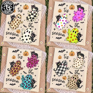 May include: Four white fabric panels featuring repeating Halloween-themed illustrations of ghosts with various patterns, black cats, pumpkins, and bats. The text 'tis the season' is printed in black script across each panel, accompanied by small stars.